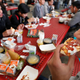 Junior high boy bites into piece of pizza in cafeteria